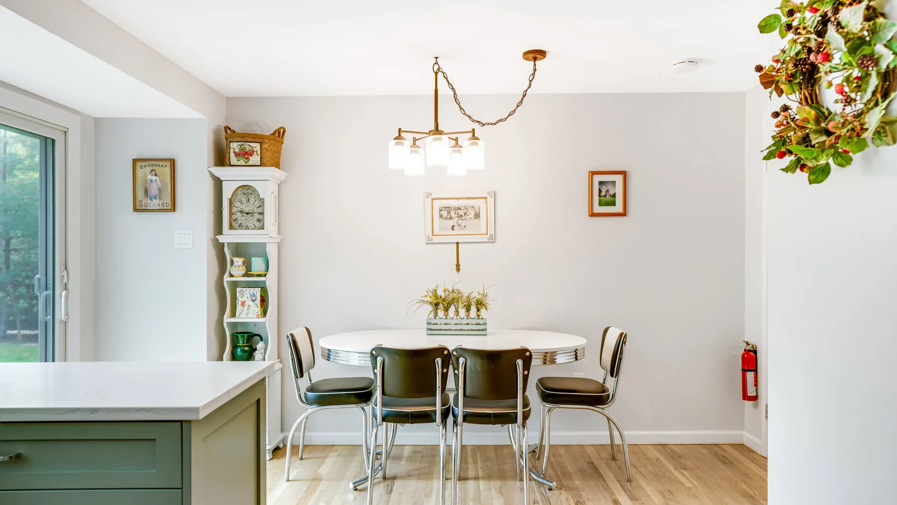 A bright dining area with a round table and surrounding seating.