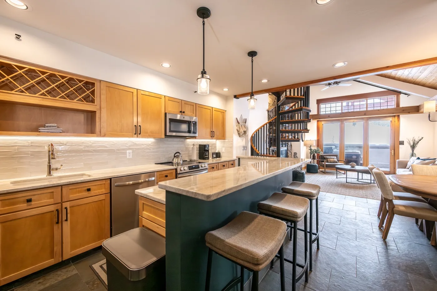An open kitchen and dining area with a long island and seating.