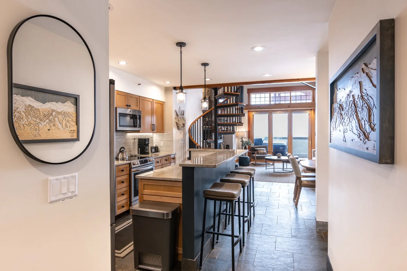An open-plan kitchen and dining area features a long island with bar seating.