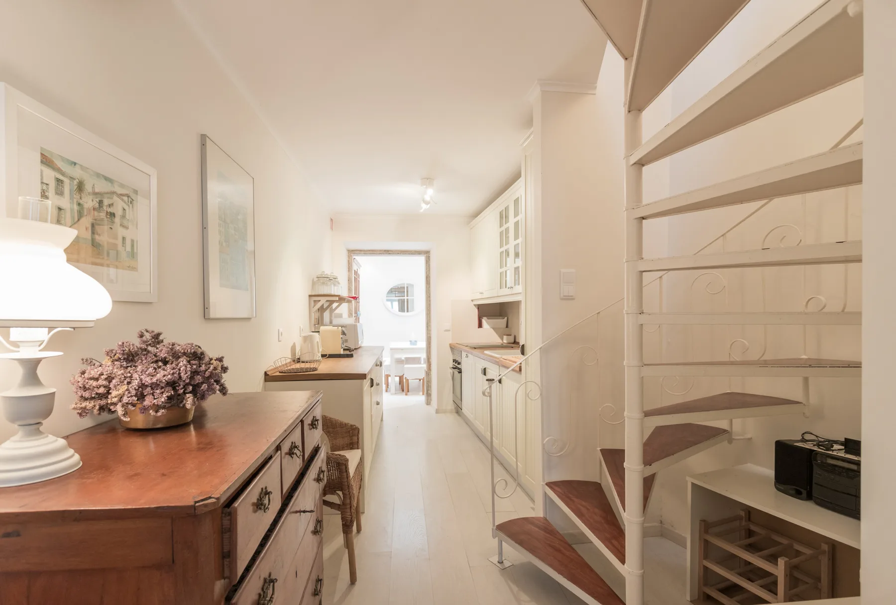A bright kitchen with a wooden counter and open shelving.