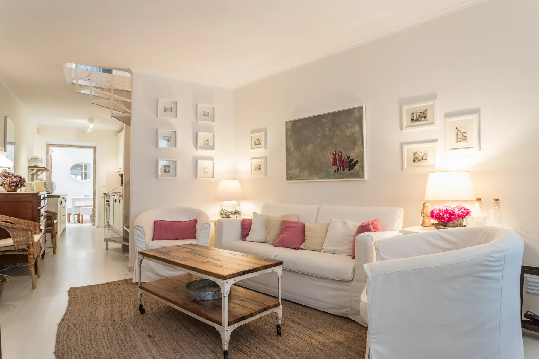 A bright living room with a sofa, armchair, and coffee table.