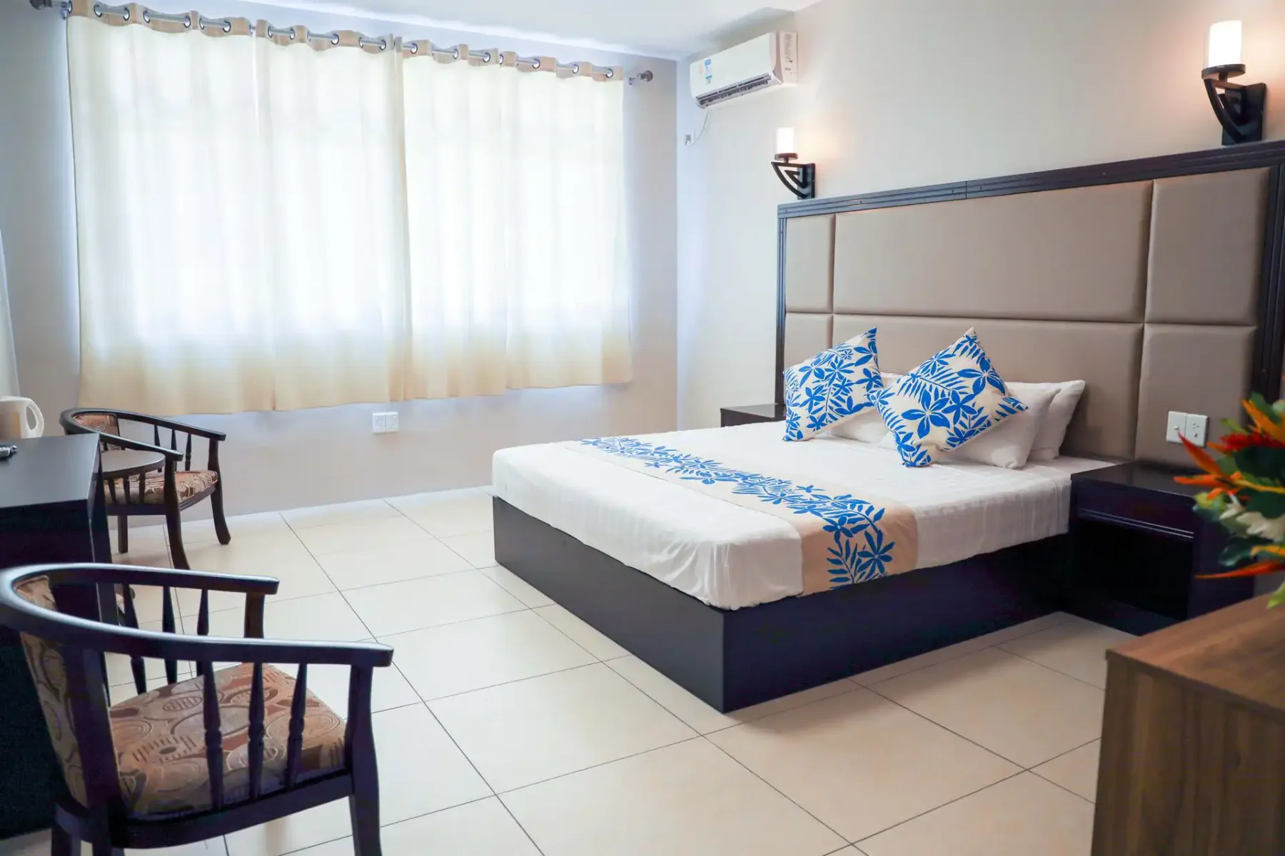 VIP room with bed, desk and chairs.