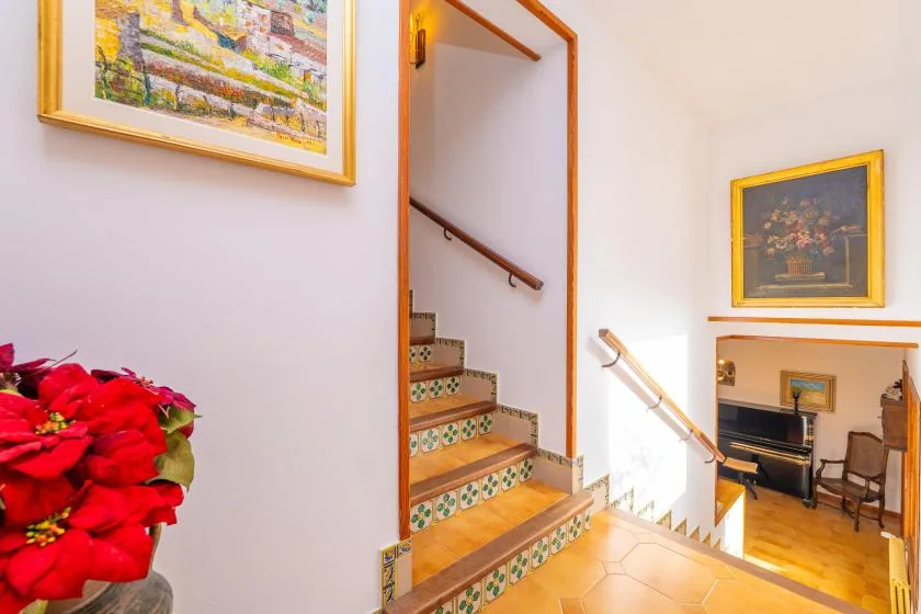 An interior staircase leads down to a furnished sitting area.