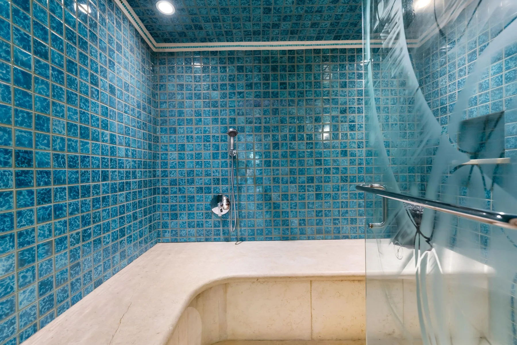 Un baño alicatado con ducha y una bañera empotrada.
