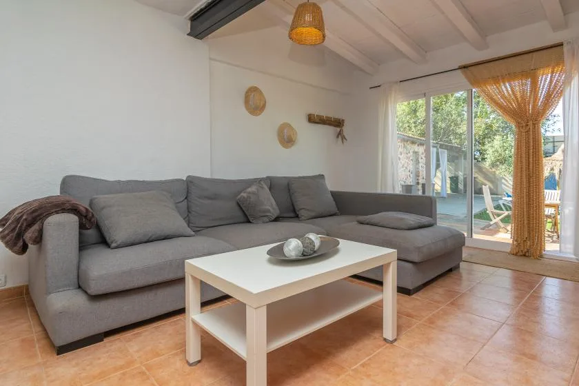 A living room with gray seating and a white coffee table.