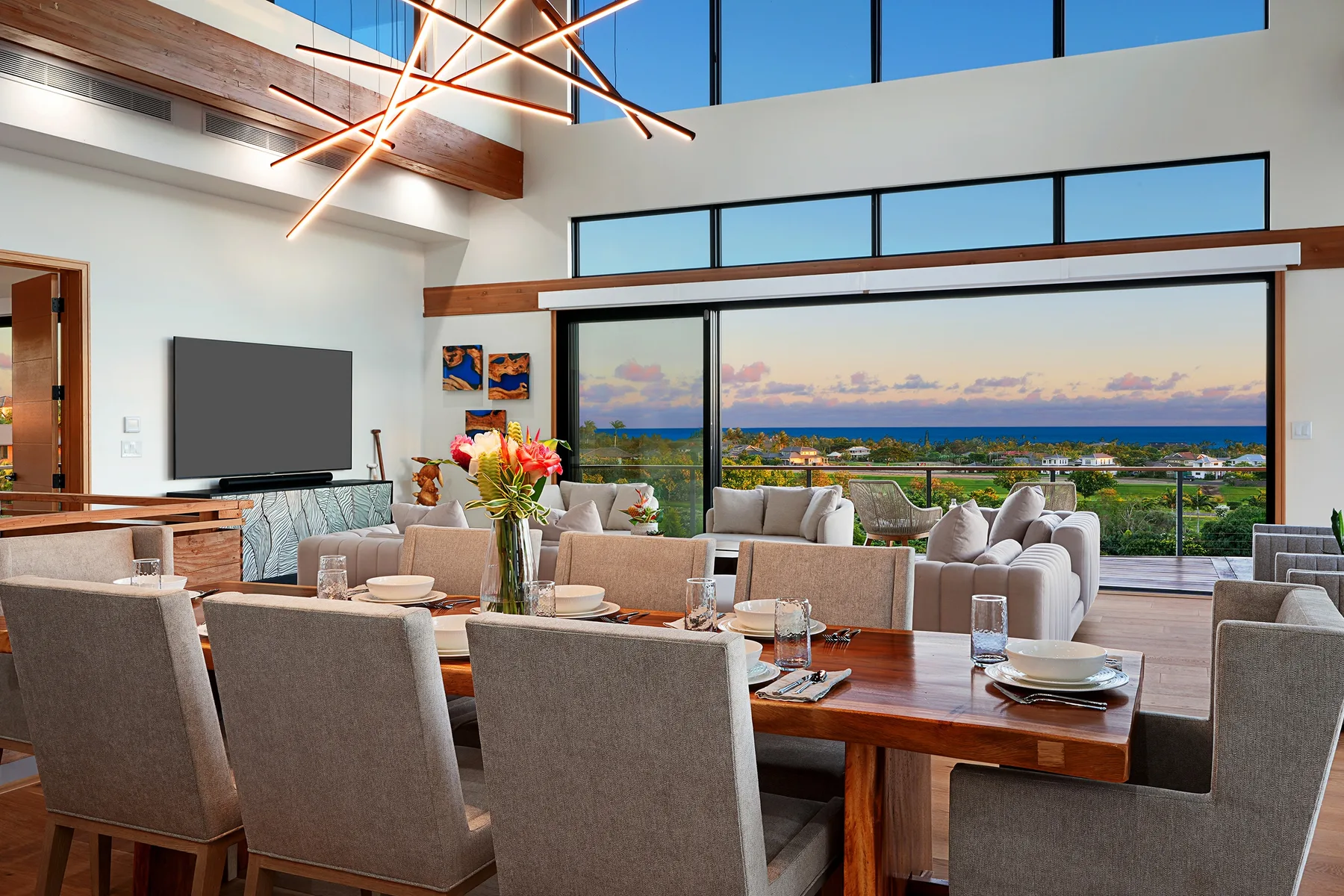 A spacious dining and living area with large windows overlooking the coast.