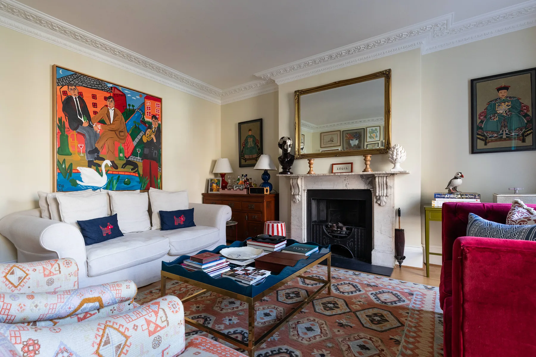 A living room with seating around a coffee table and a fireplace.