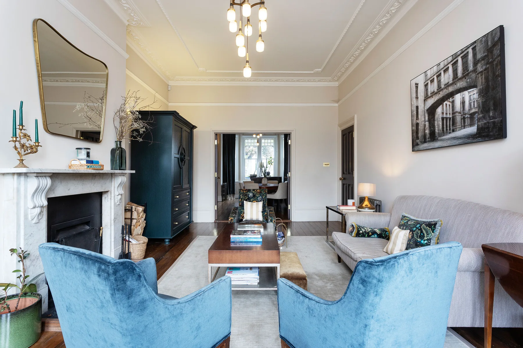 A living room with blue seating, a fireplace, and a coffee table.