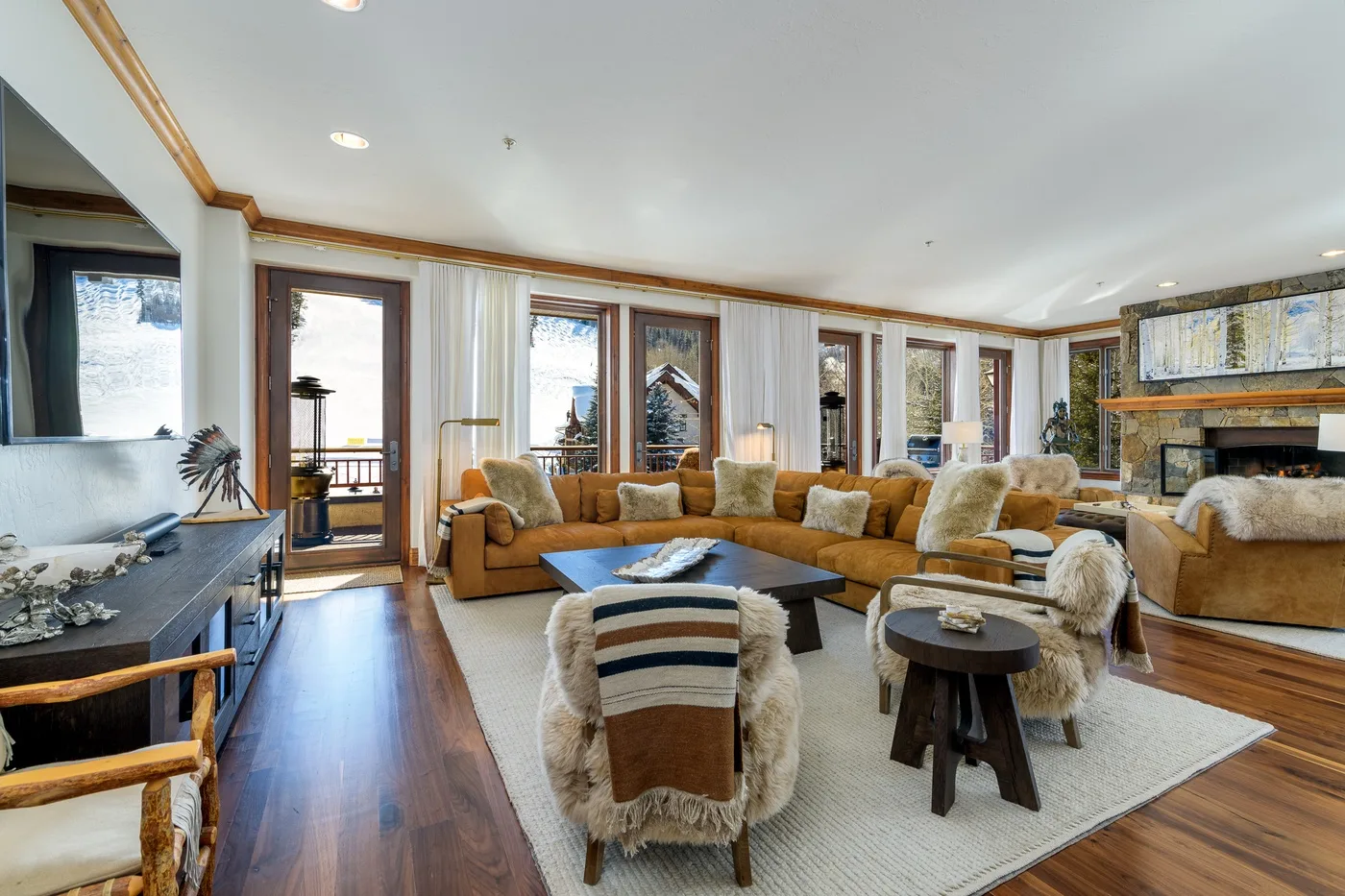 A bright living room with seating arranged around a low coffee table.