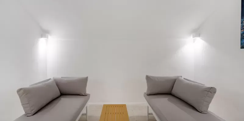 A bright seating area with two sofas facing a low wooden table.