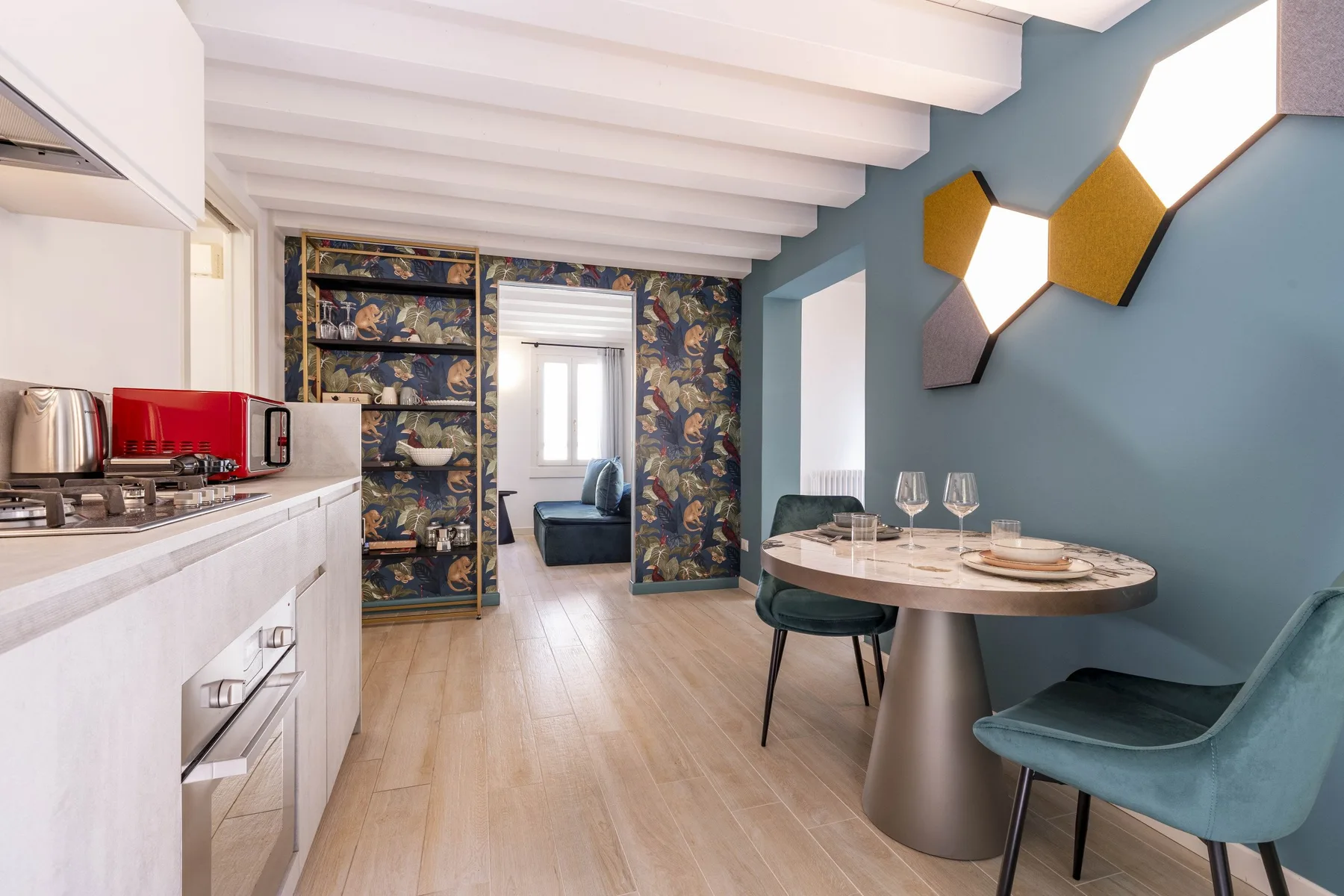 An open-plan kitchen and dining area with a table beside the kitchen.