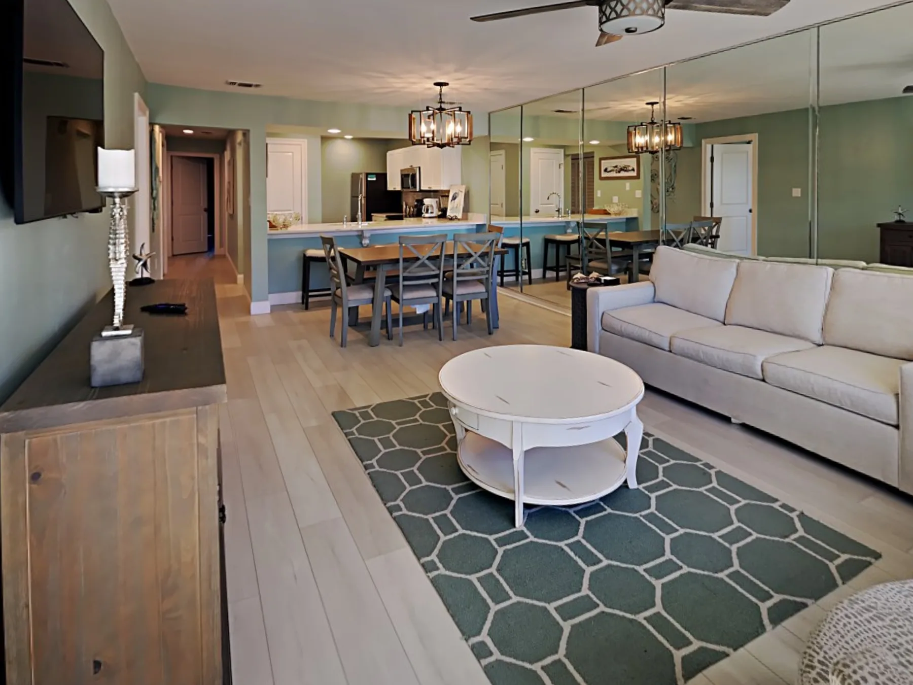 A living and dining area with a sofa, coffee table, and dining table.