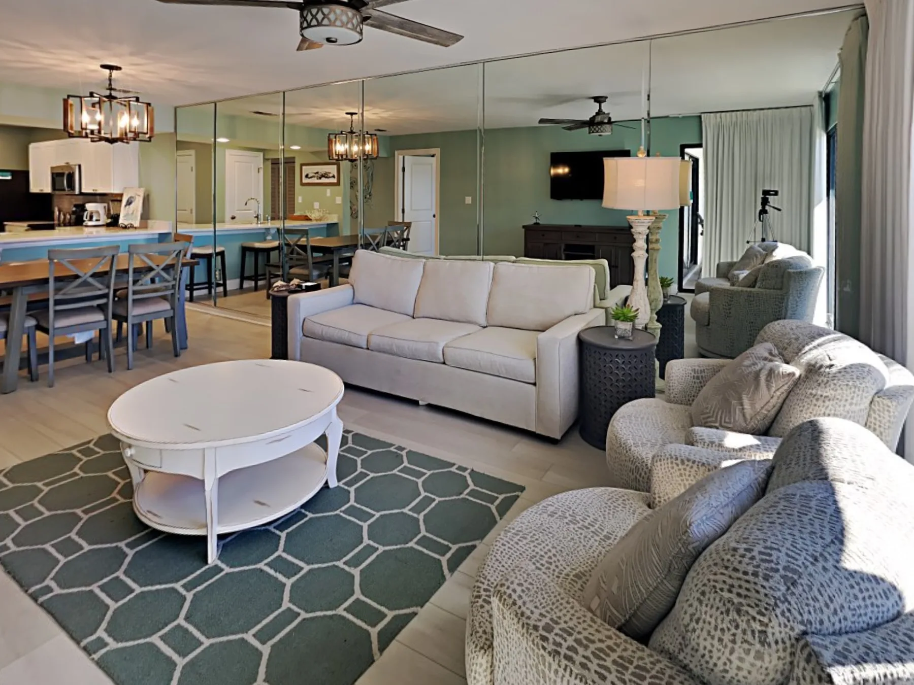 A living room with a sofa, armchairs, and a dining table.