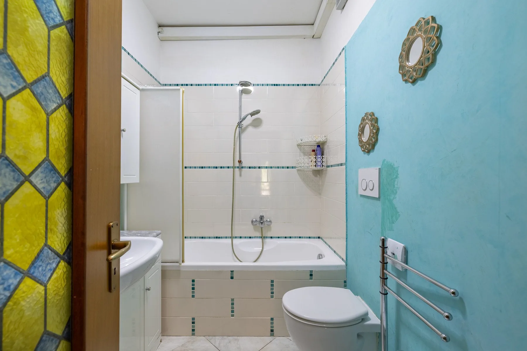 A bathroom with a bathtub, shower, and toilet.