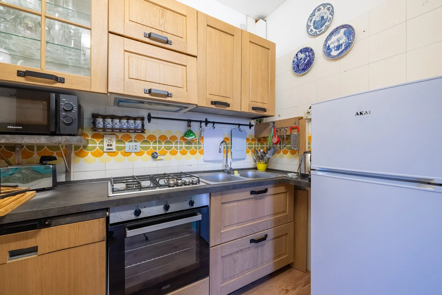 A kitchen with wooden cabinets, a countertop, and a stove.