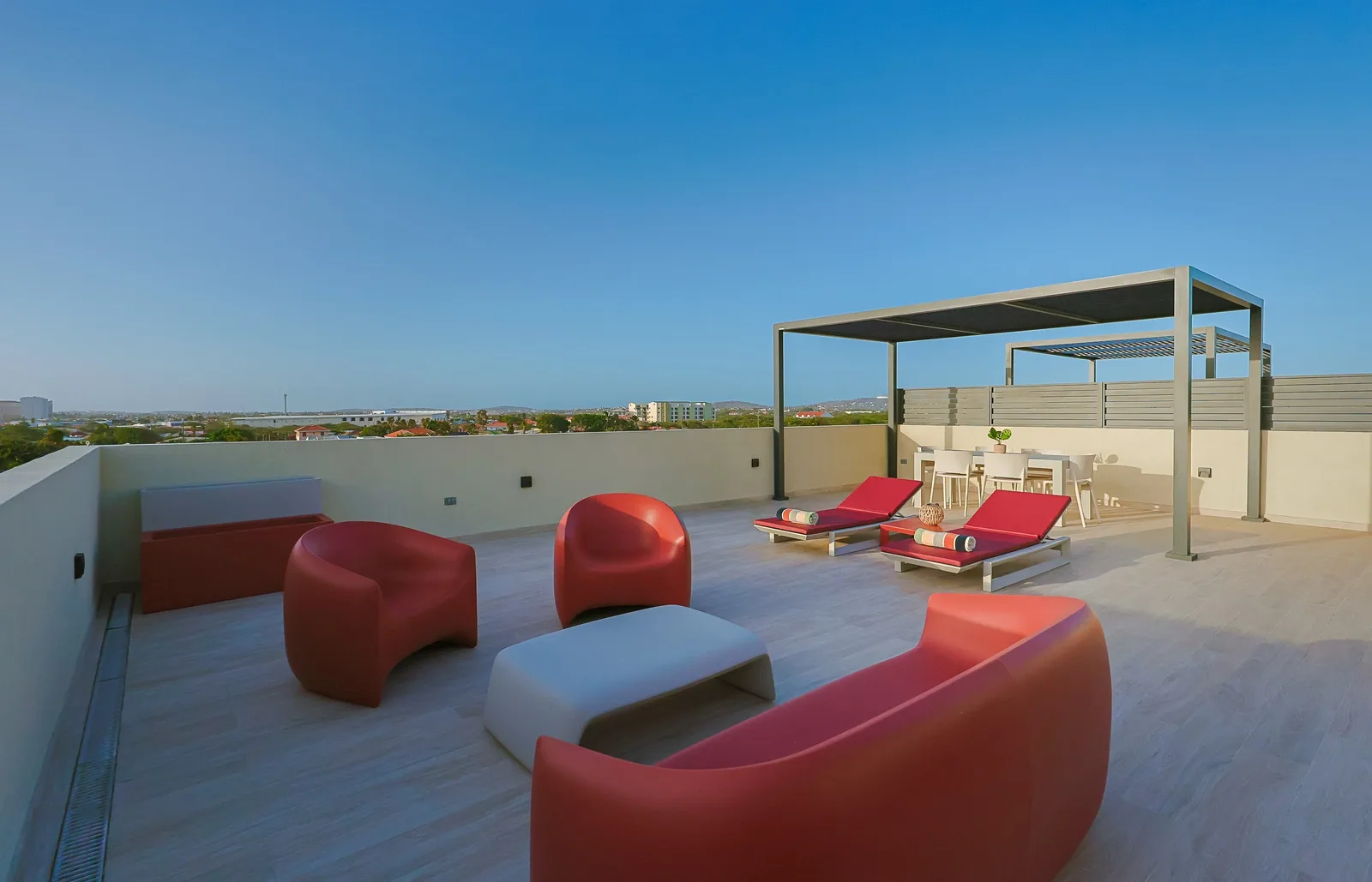 Modern, colorful , sculptural loungers offers the perfect spot to unwind, soak up the Aruba sunshine, and enjoy a peaceful outdoor retreat.