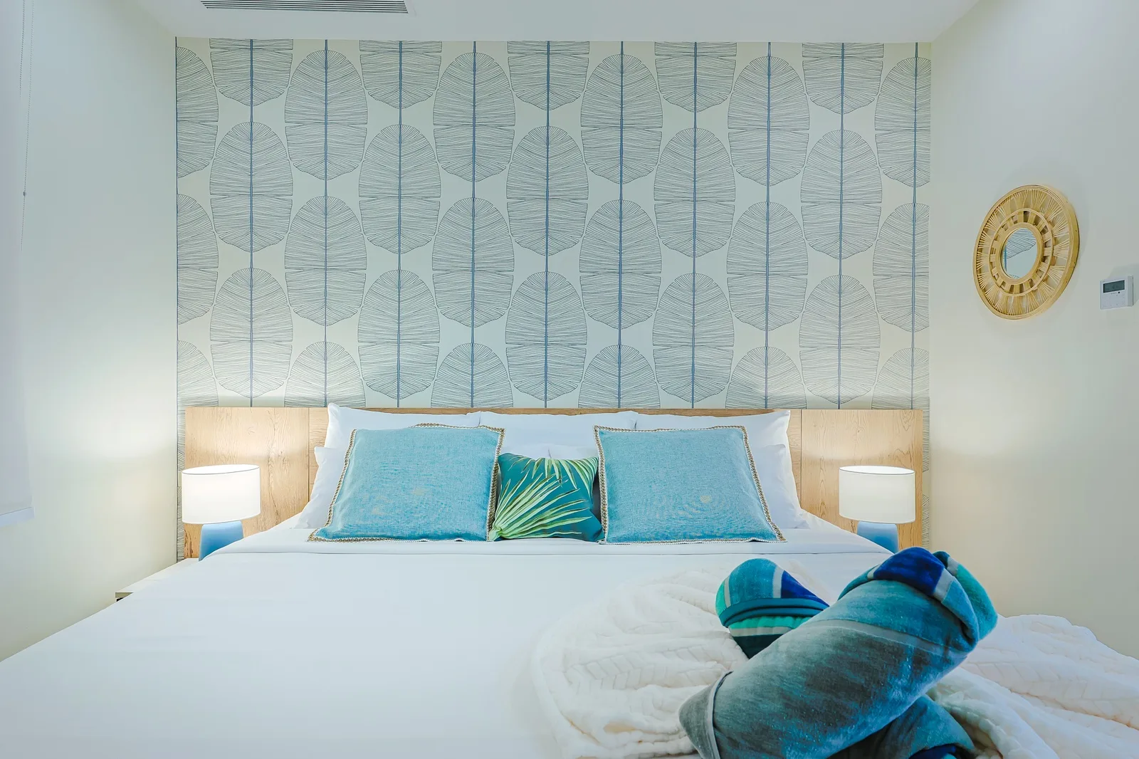 Sink into crisp white linens in your serene bedroom, where coastal-inspired decor and soft blue accents create the perfect retreat after a day of exploring.