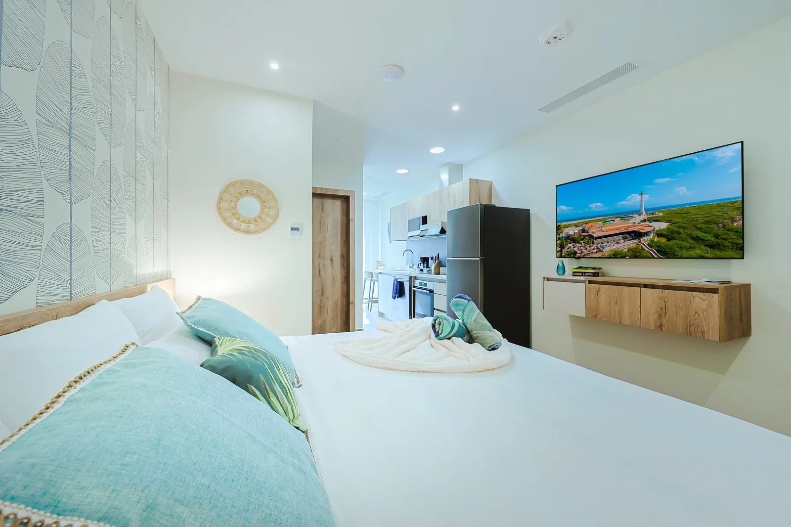 Relax in your bright, modern studio with plush bedding, a full kitchen with stainless appliances, and coastal-themed decor. Watch shows on the flat-screen TV or whip up meals—everything you need for a comfortable stay.
