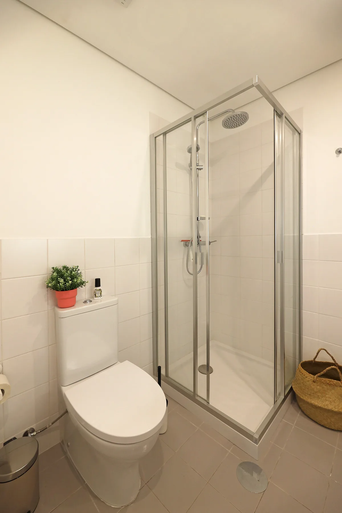 A bathroom with a glass shower and a toilet.