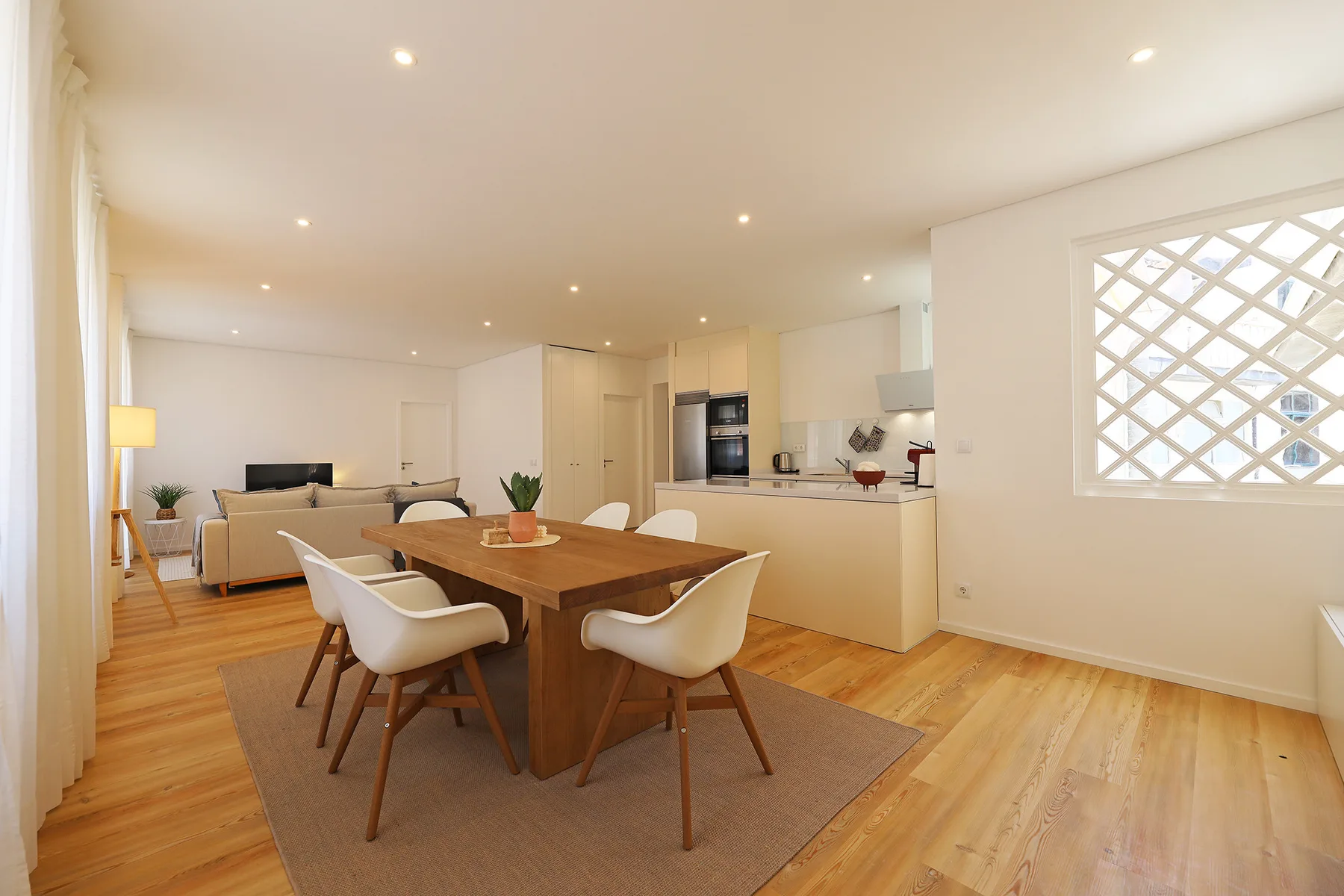 An open-plan living and dining area with a wooden table and seating.