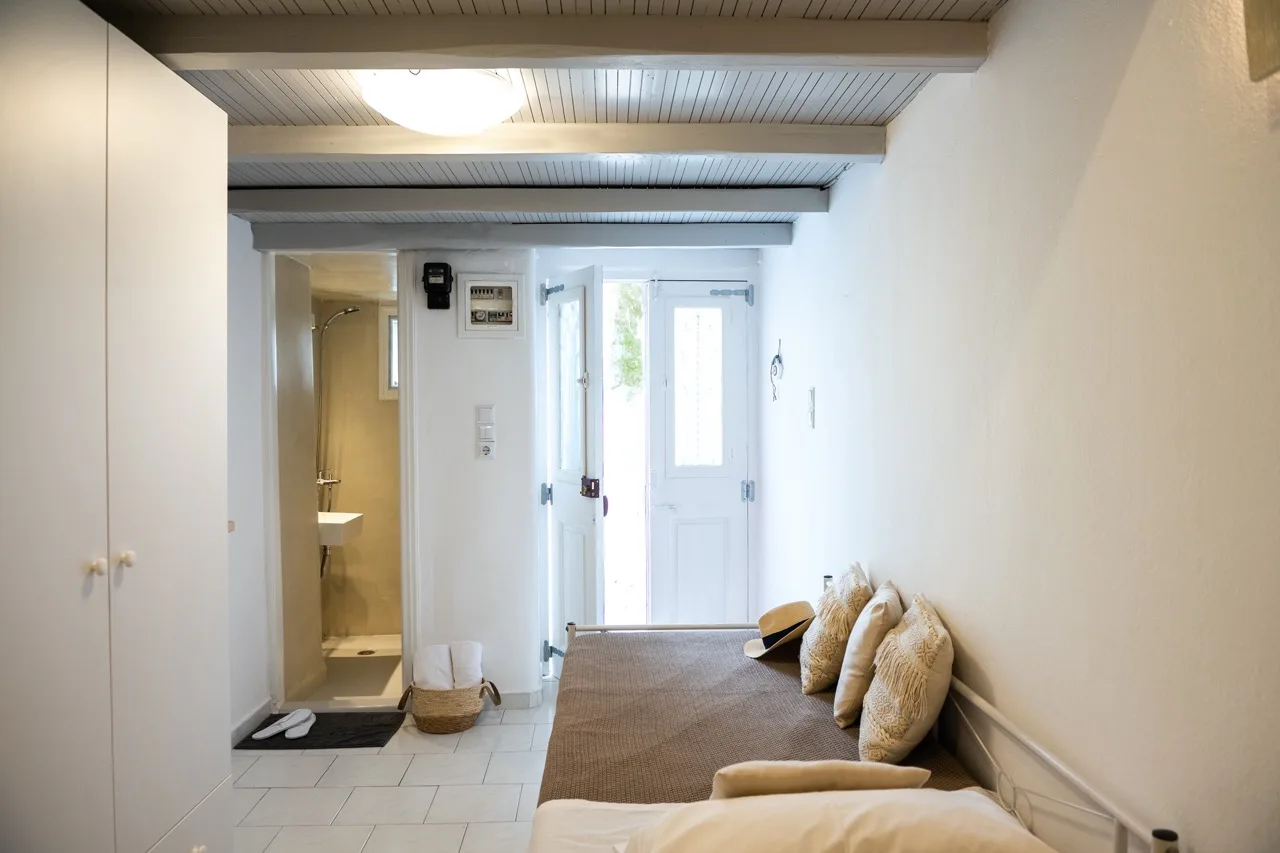 A bright entry room with a doorway, built-in storage, and seating.