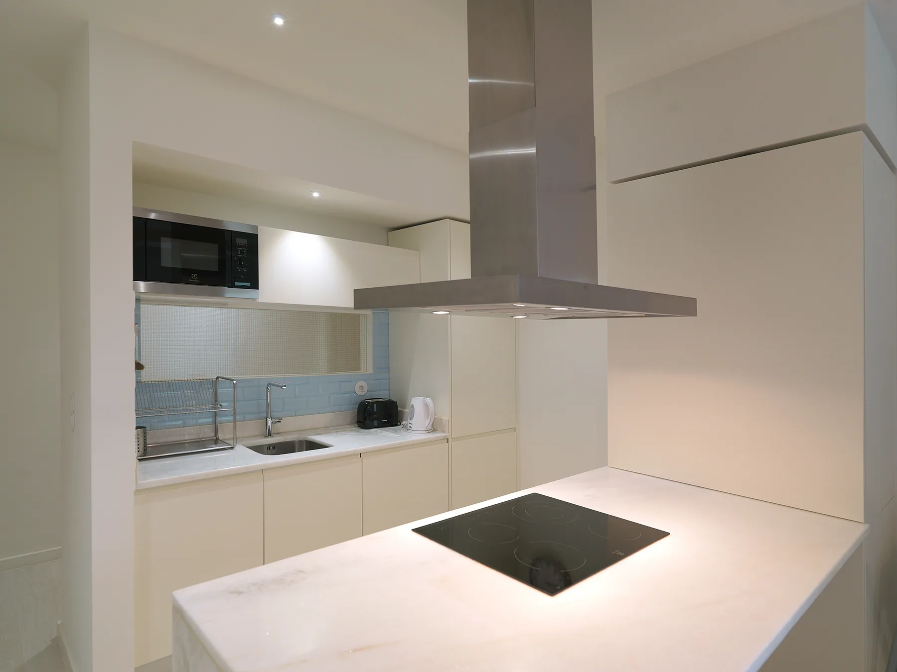 A modern kitchen with a cooktop set into a large island.