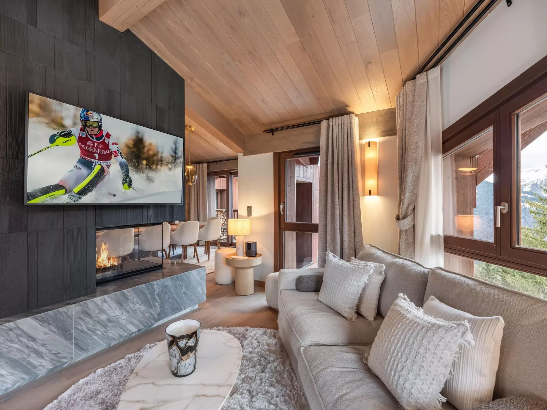 Una sala de estar con un sofá claro, una chimenea y un televisor.