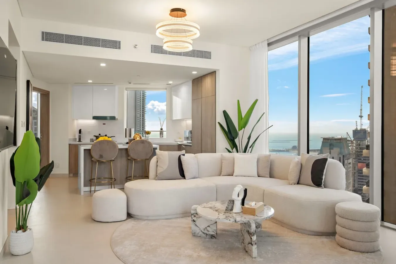 A bright living room with a sectional seating area facing large windows.