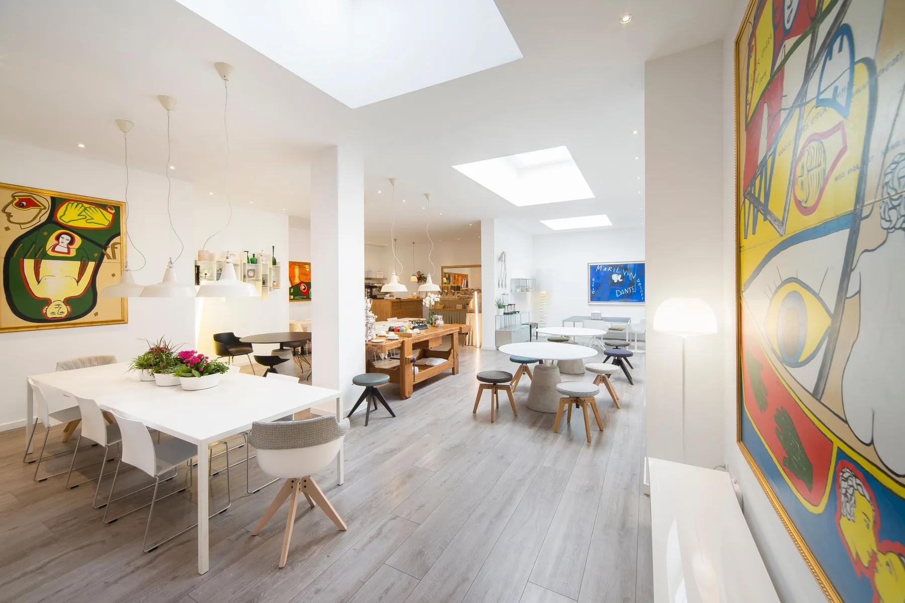 Hotel interior with dining tables and skylights.