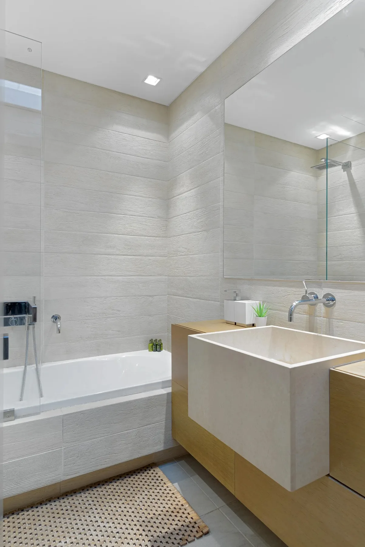 A modern bathroom with a bathtub and a large sink.