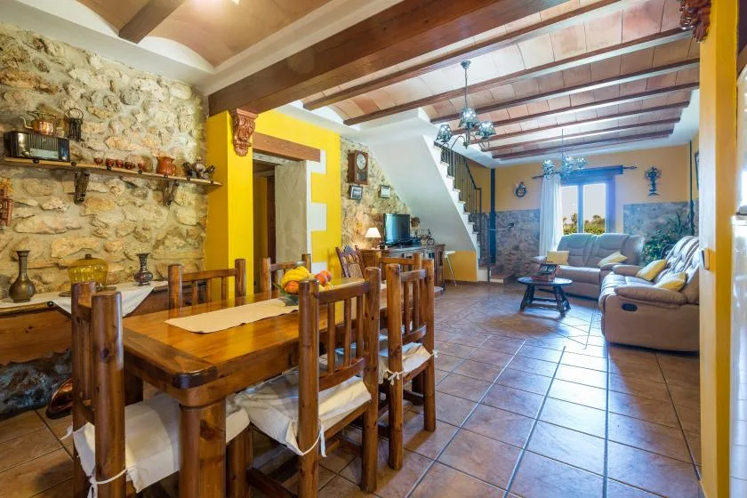 A rustic dining and living area with a wooden table and seating.