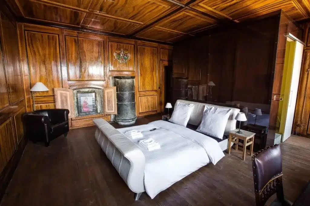 Suite with period woodwork and a white leather bed