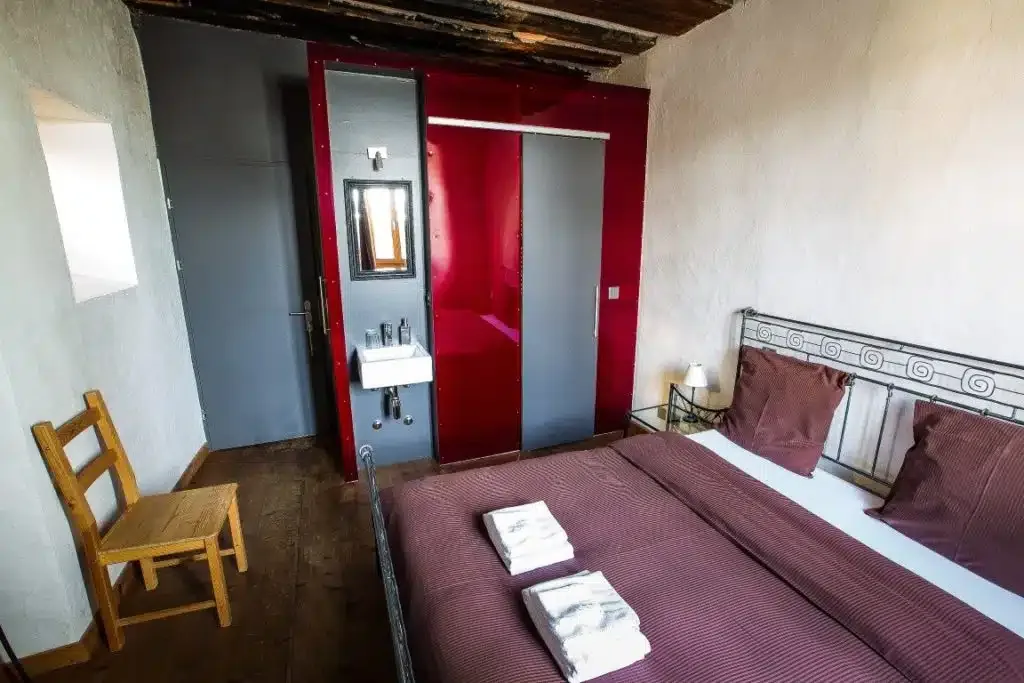 Comfort room 1 with a large iron bed