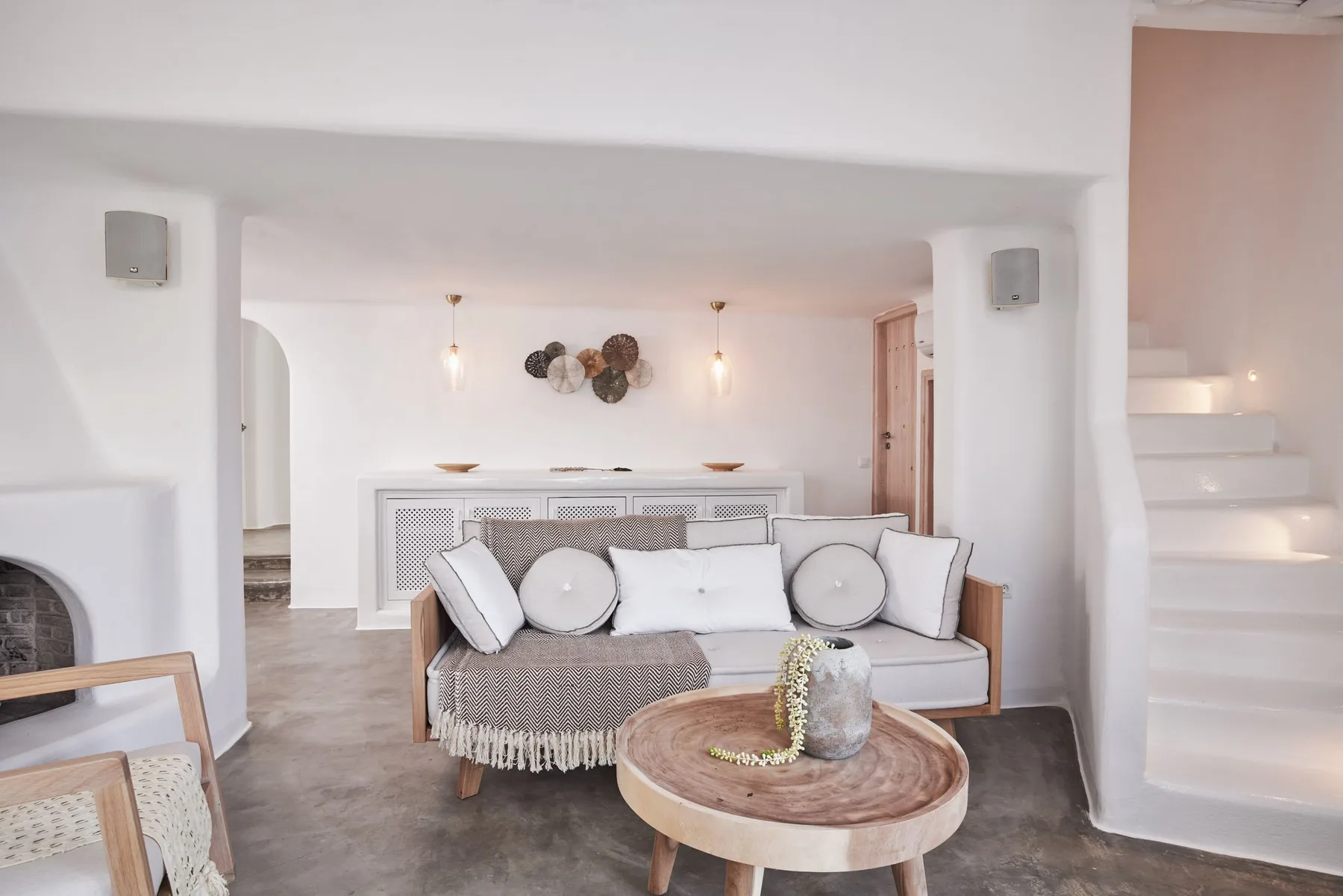 A bright living room with a sofa and a round coffee table.