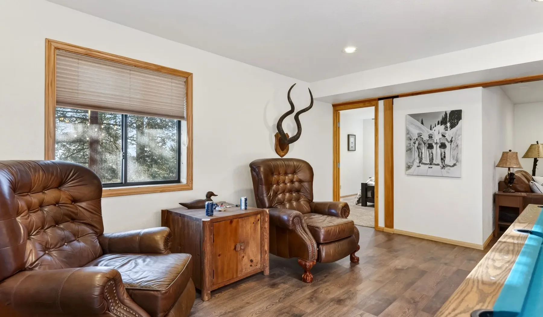 A sitting area with leather seating and a wooden side table.