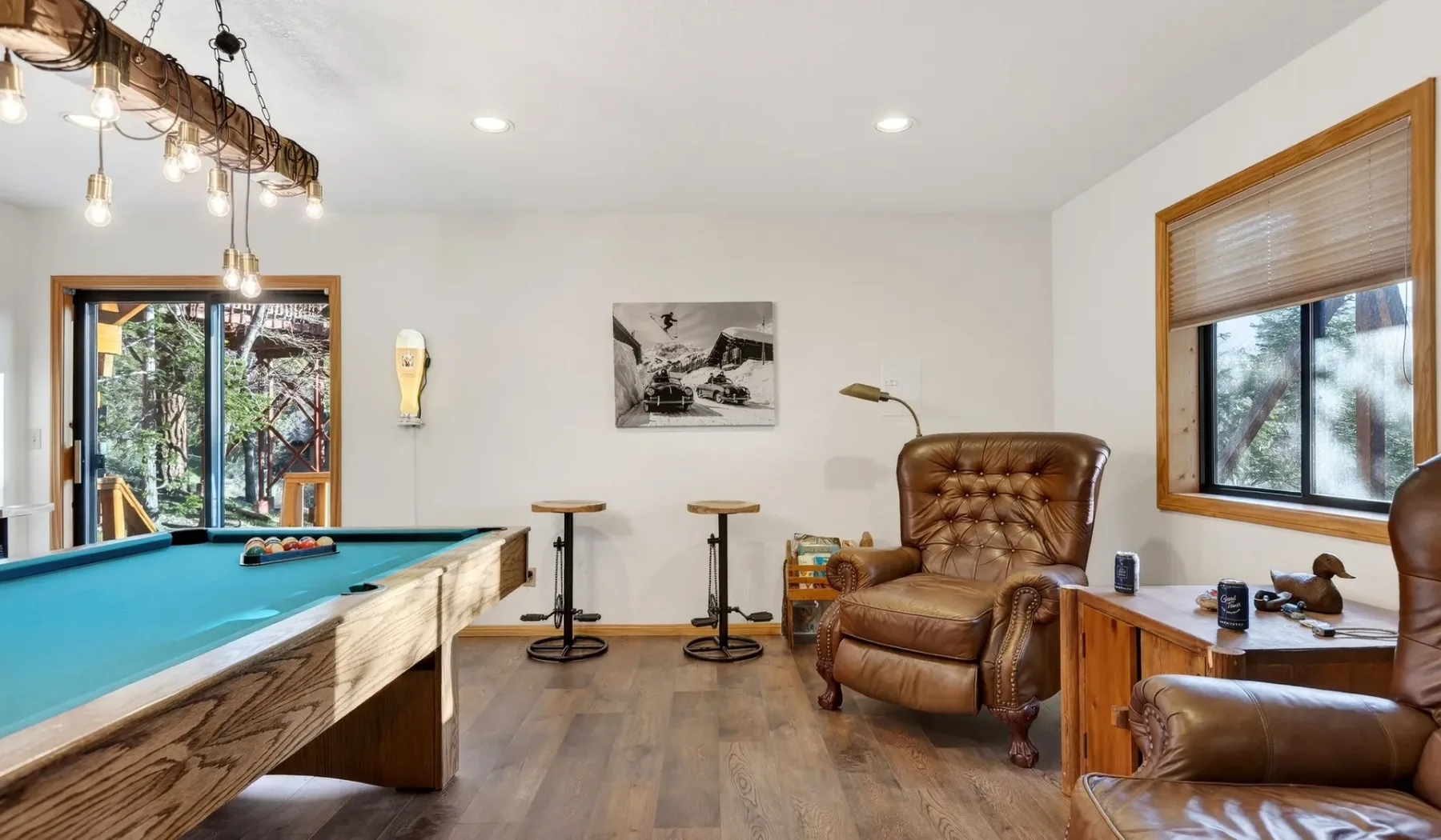 A game room with a pool table and leather seating.