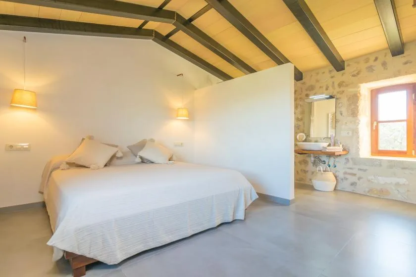 Bedroom with a bed and an adjoining bathroom area.
