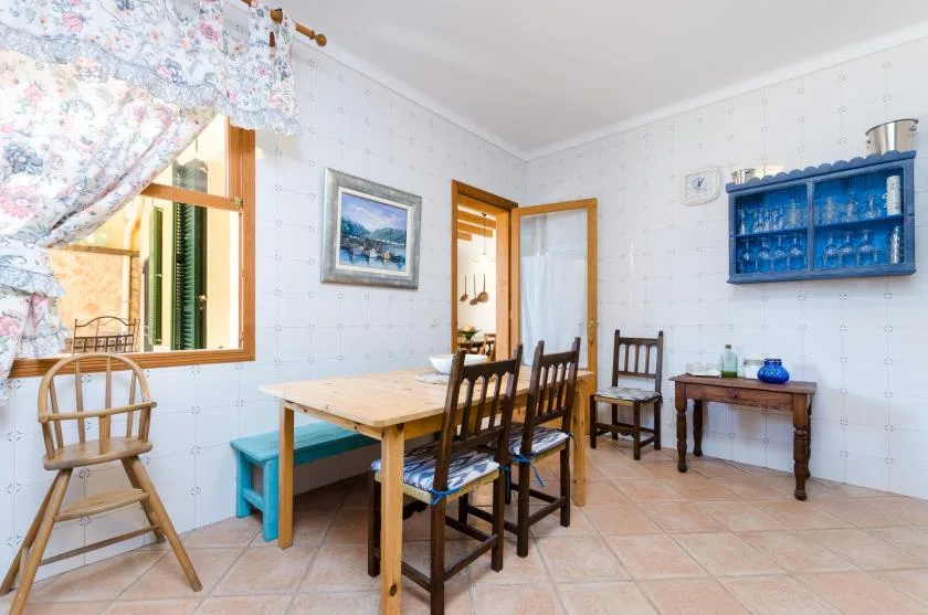 A dining area with a wooden table and several chairs.