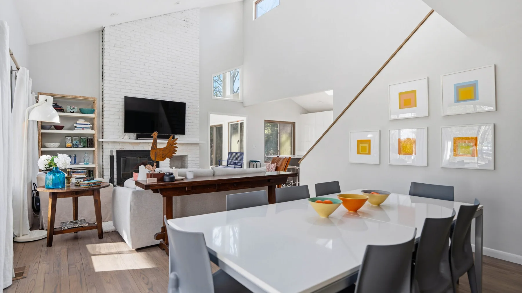 A bright open-plan living and dining area with a table and seating.