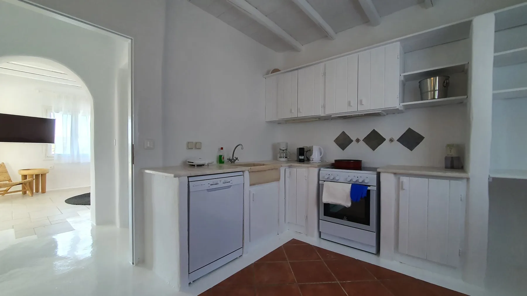A kitchen with white cabinets, a countertop, and an oven.