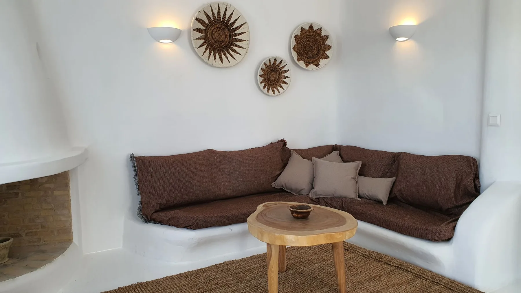 A living area has brown seating around a wooden coffee table.