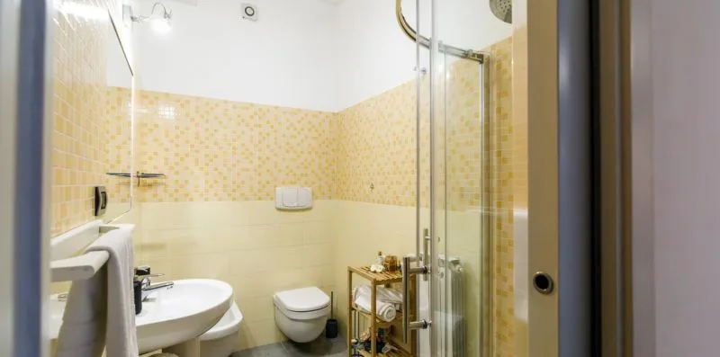 A bathroom with a sink, toilet, and glass shower.