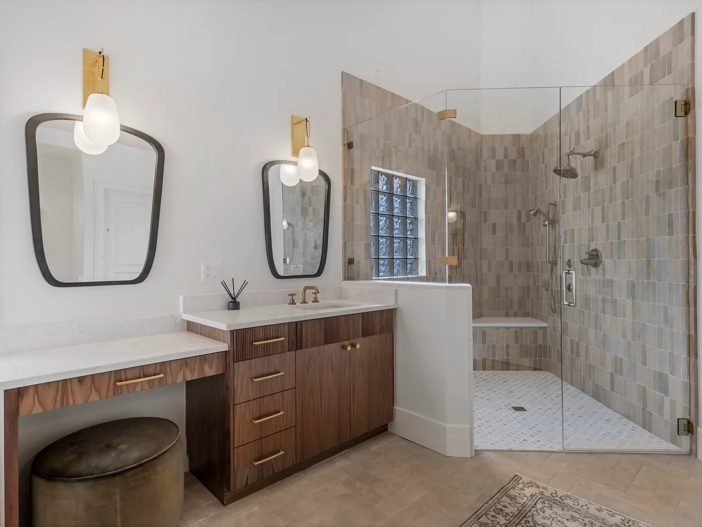 A modern bathroom with a double vanity and a glass-enclosed shower.