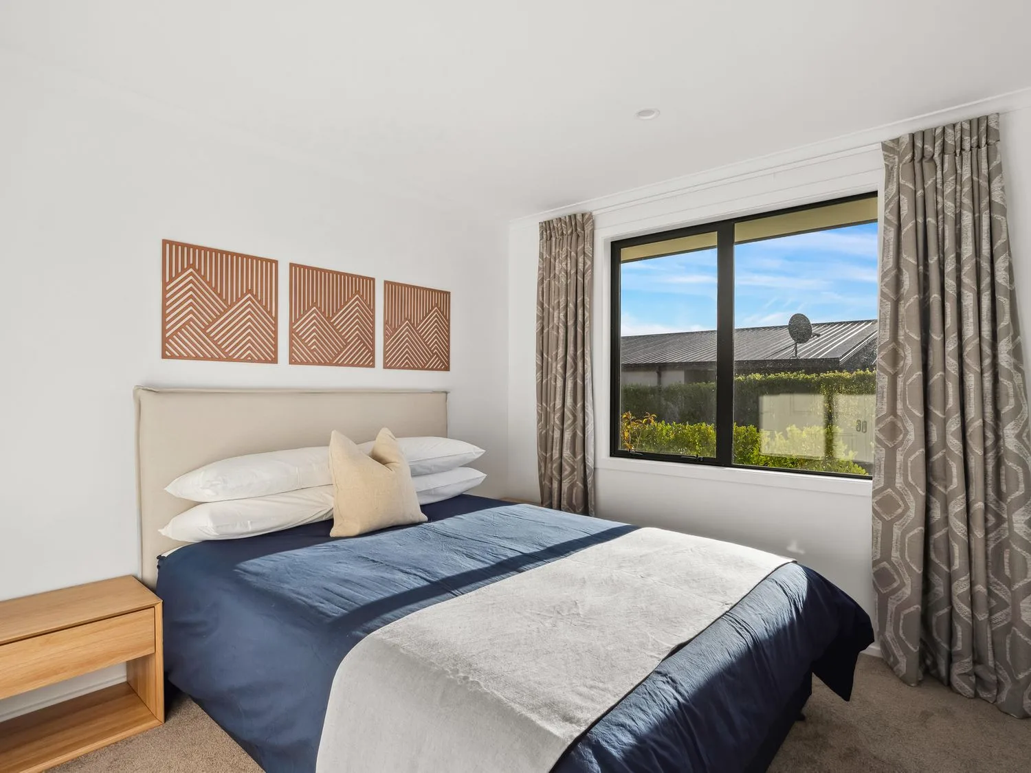 A bedroom with a bed and window at Mako Haven - Mountain Outlook, Wanaka