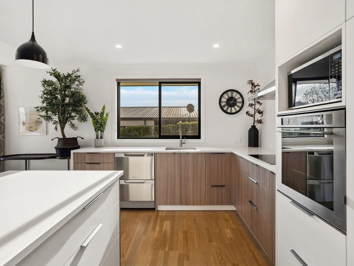 A kitchen with sink, oven, and plants at Mako Haven - Mountain Outlook in Wanaka