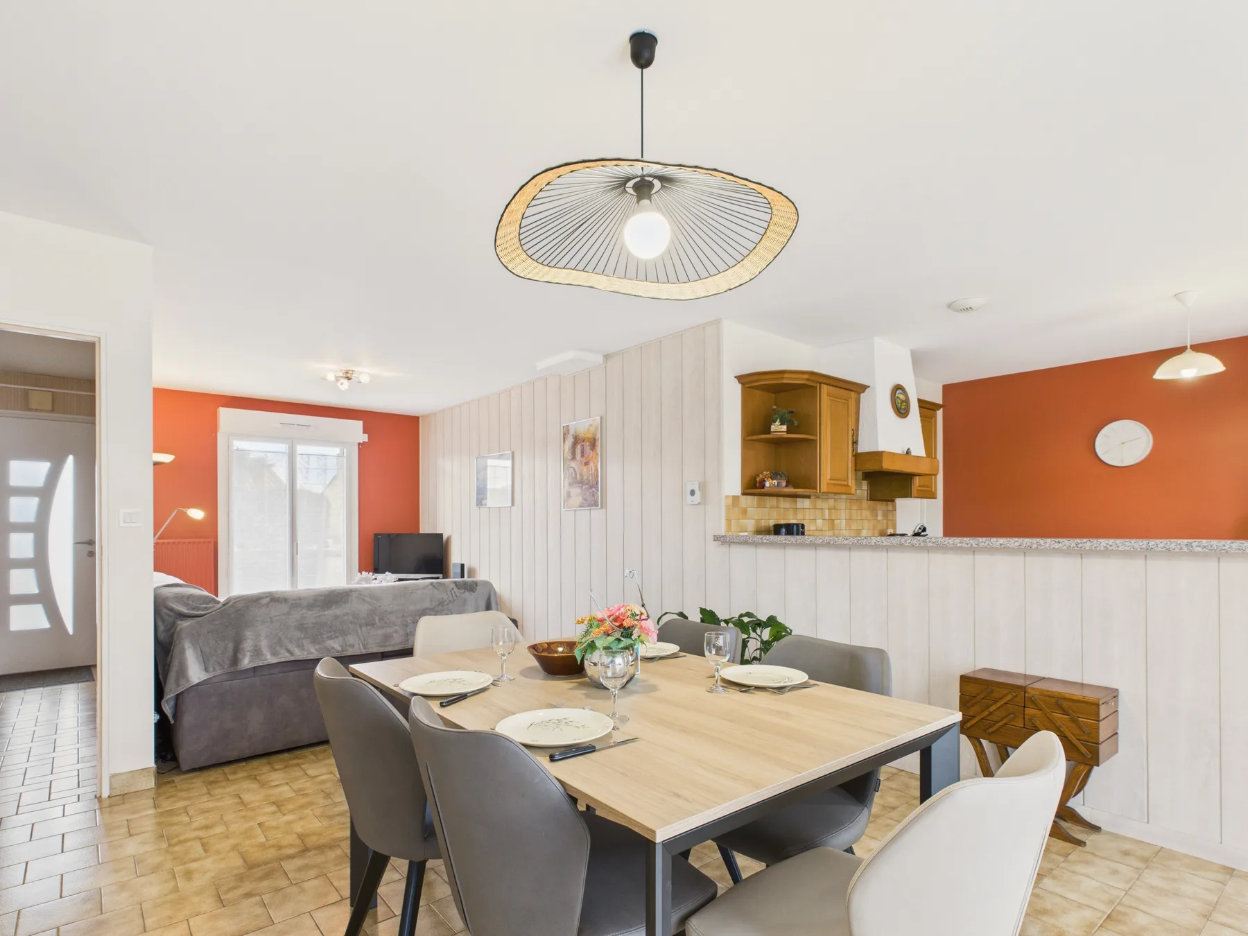 An open living and dining area with a table set beside the seating area.