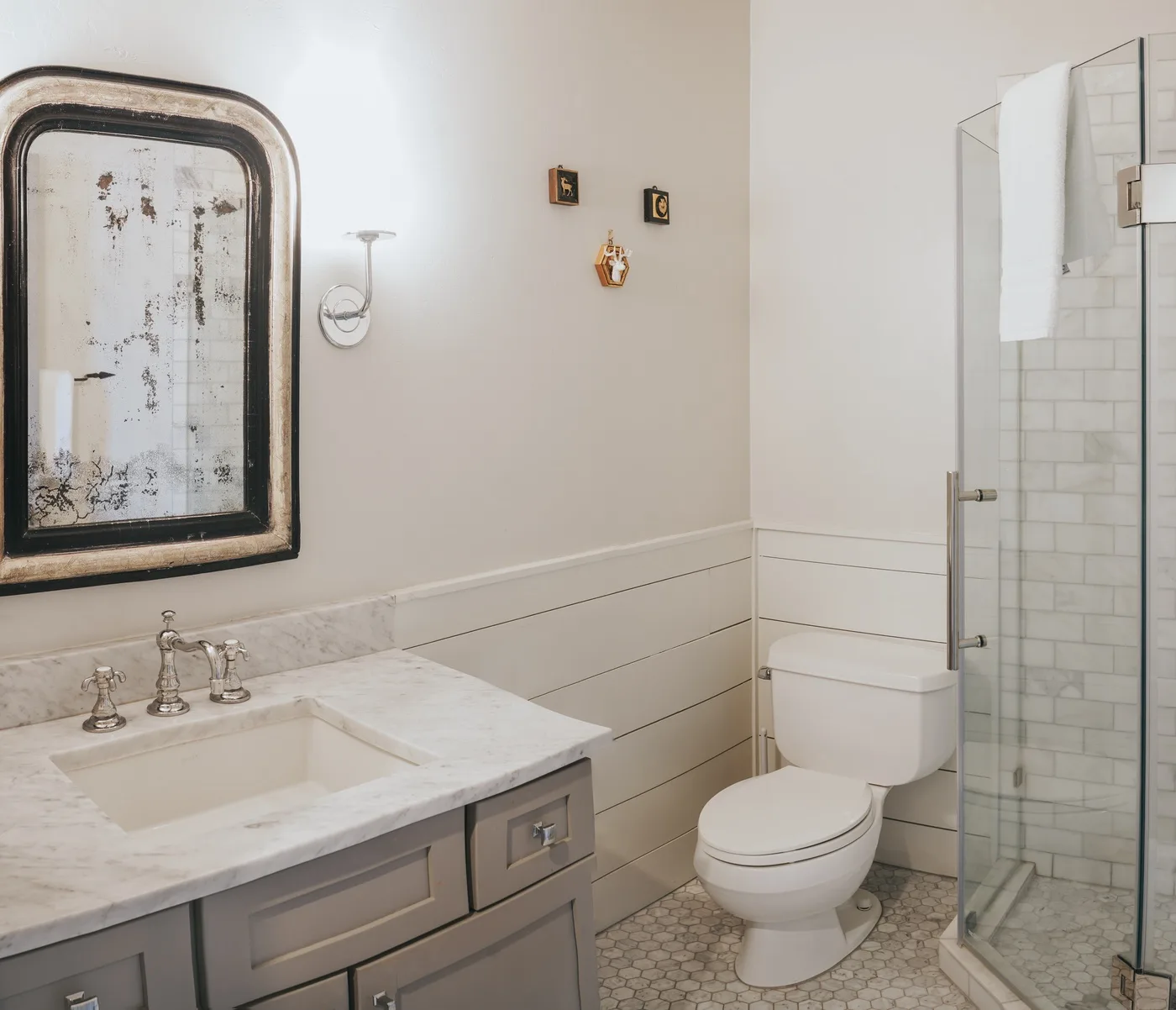 A bathroom with a vanity, toilet, and glass shower.
