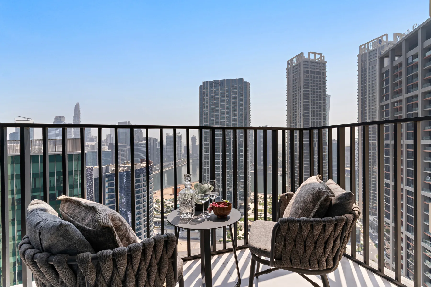 A balcony seating area overlooks a city skyline.