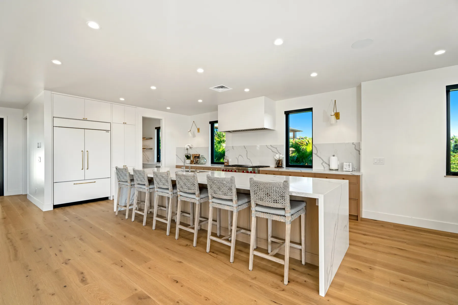 A bright kitchen with a long island and seating.
