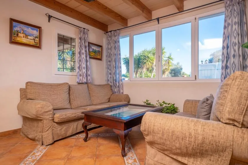 A living room with seating around a glass-topped coffee table.